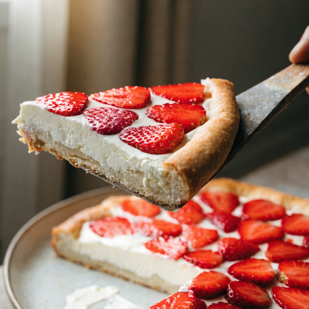 Close-up of flag fruit pizza with cream cheese topping and fresh berries