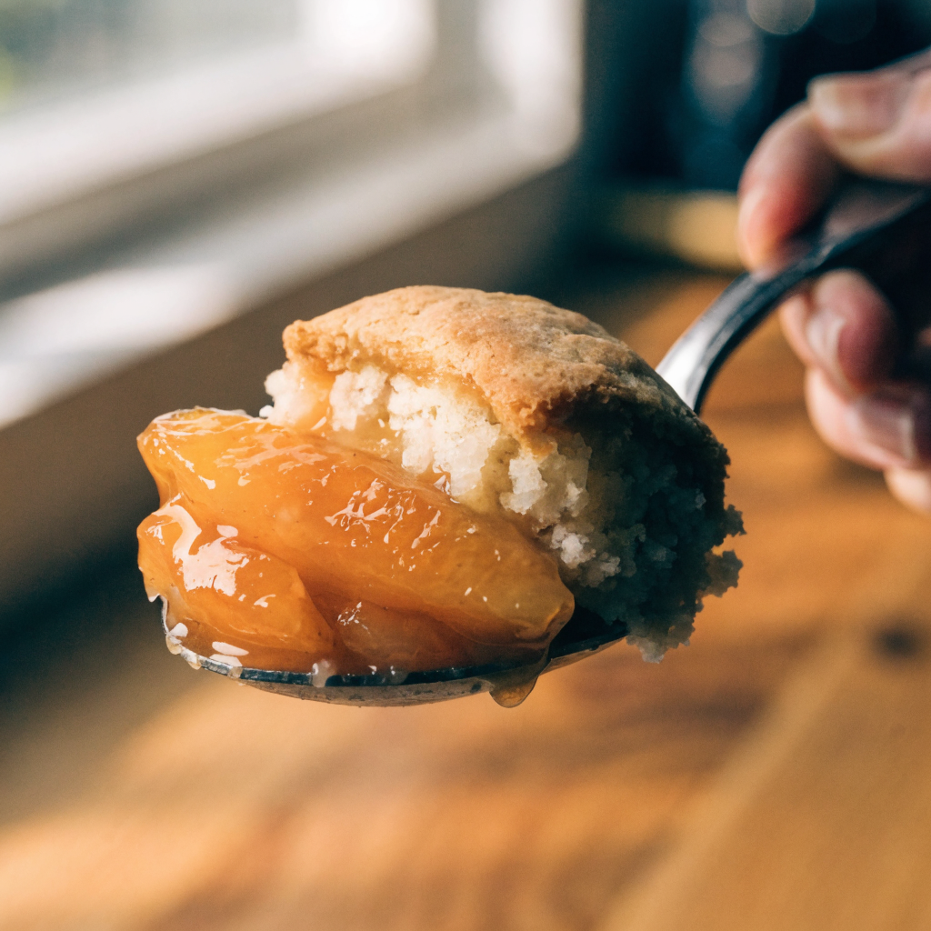 Close-up of fresh peach cobbler with drop-biscuit topping