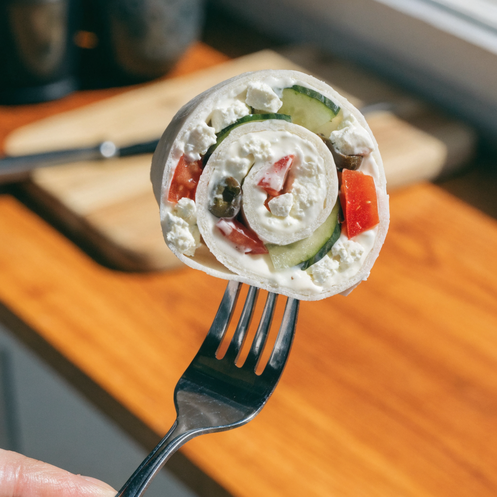 Close-up of greek salad pinwheels with yogurt-herb spread